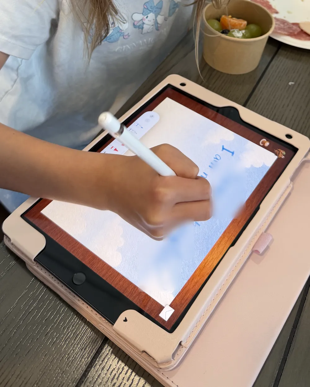 Patrick’s daughter writing a letter with an Apple Pencil